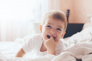 child laughing on the bed language development speecheasy